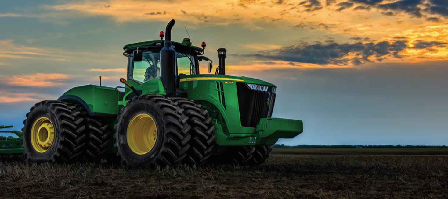 Tractor in field at sunset
